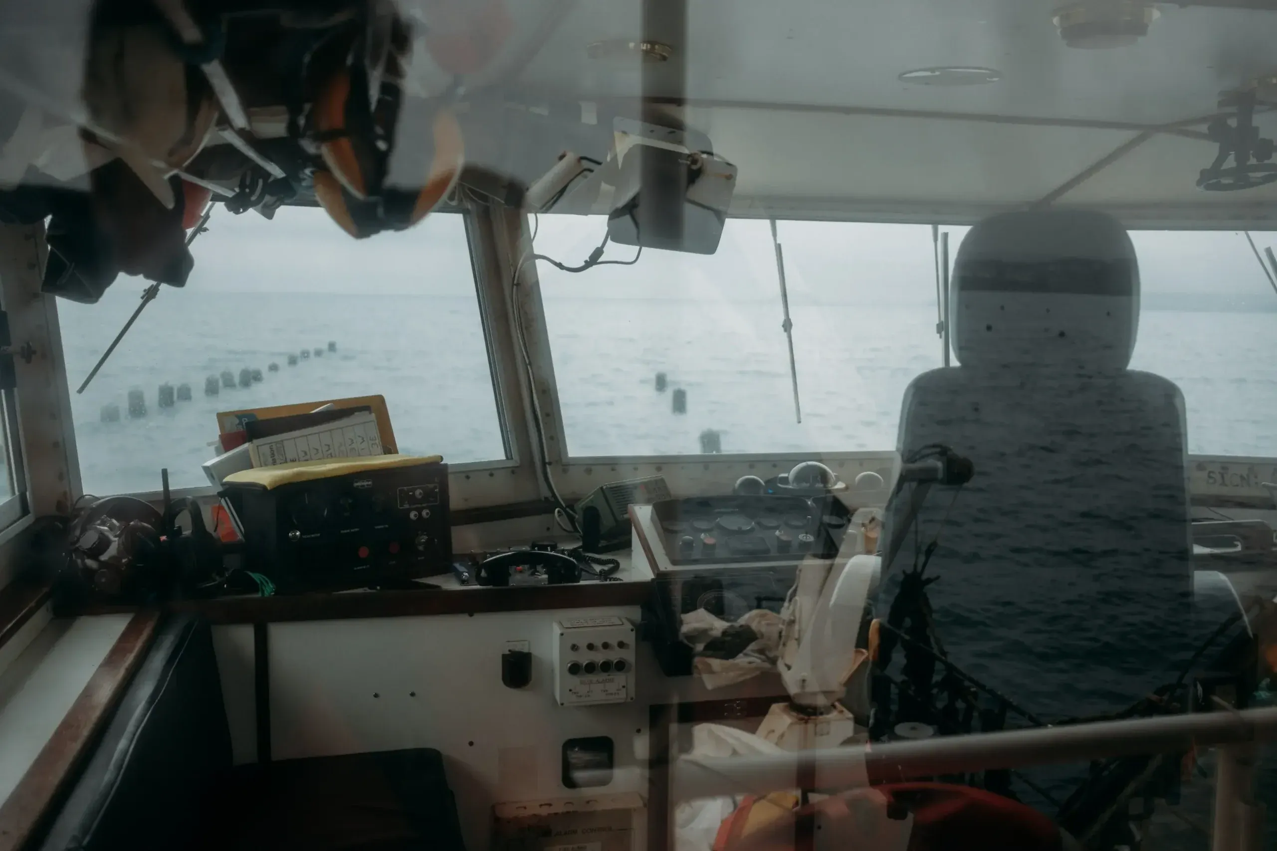 The wheelhouse of a mussel fishing boat on St Austell Bay, with Westcountry Mussels of Fowey lines visible in the water beyond