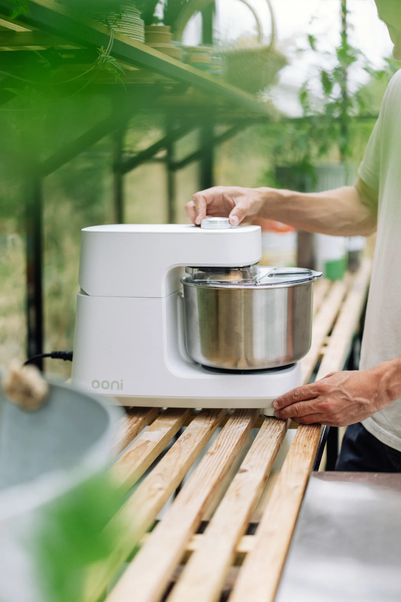 An Ooni mixer being used inside a greenhouse for a pear and ricotta recipe film