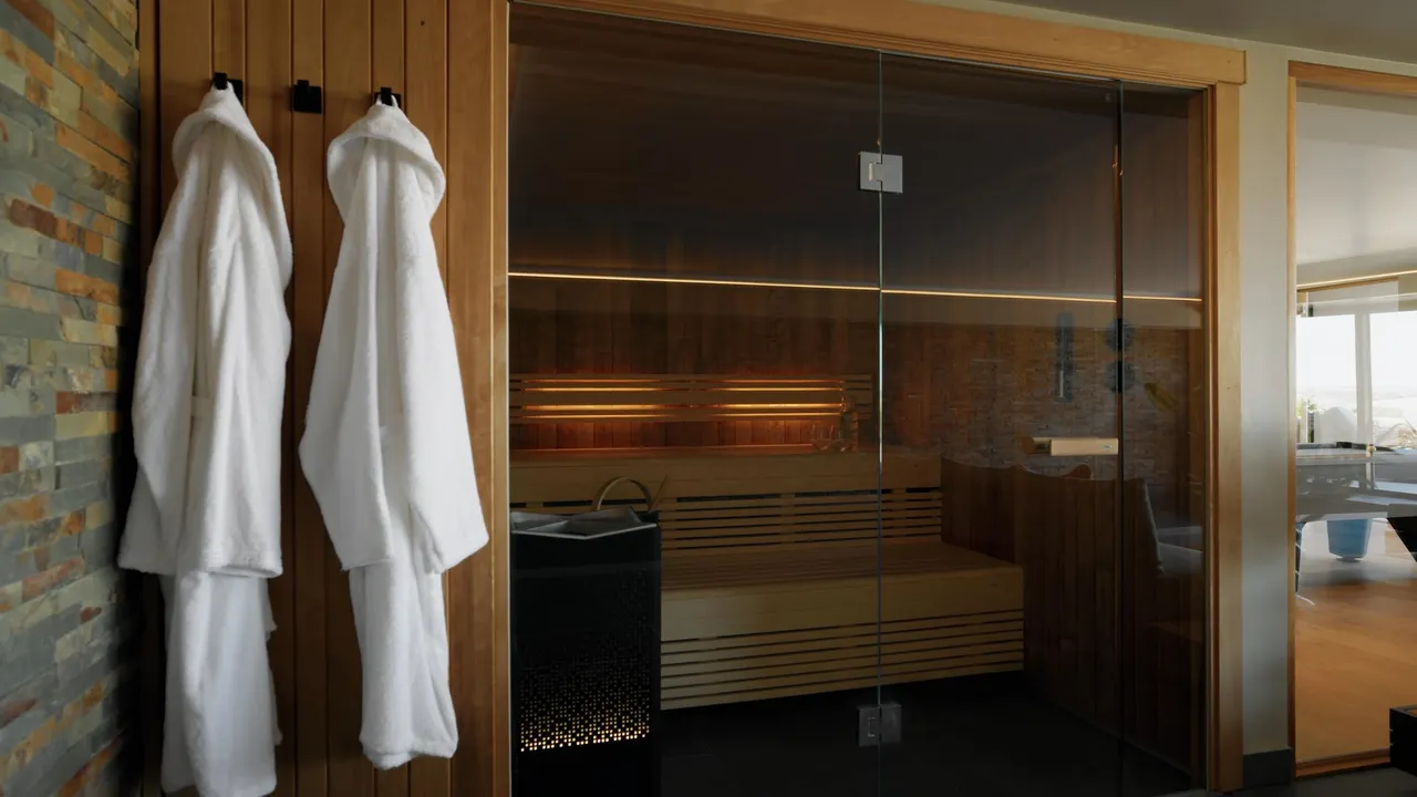 Vertical social frame from Namuri: bathrobes hung beside the sauna