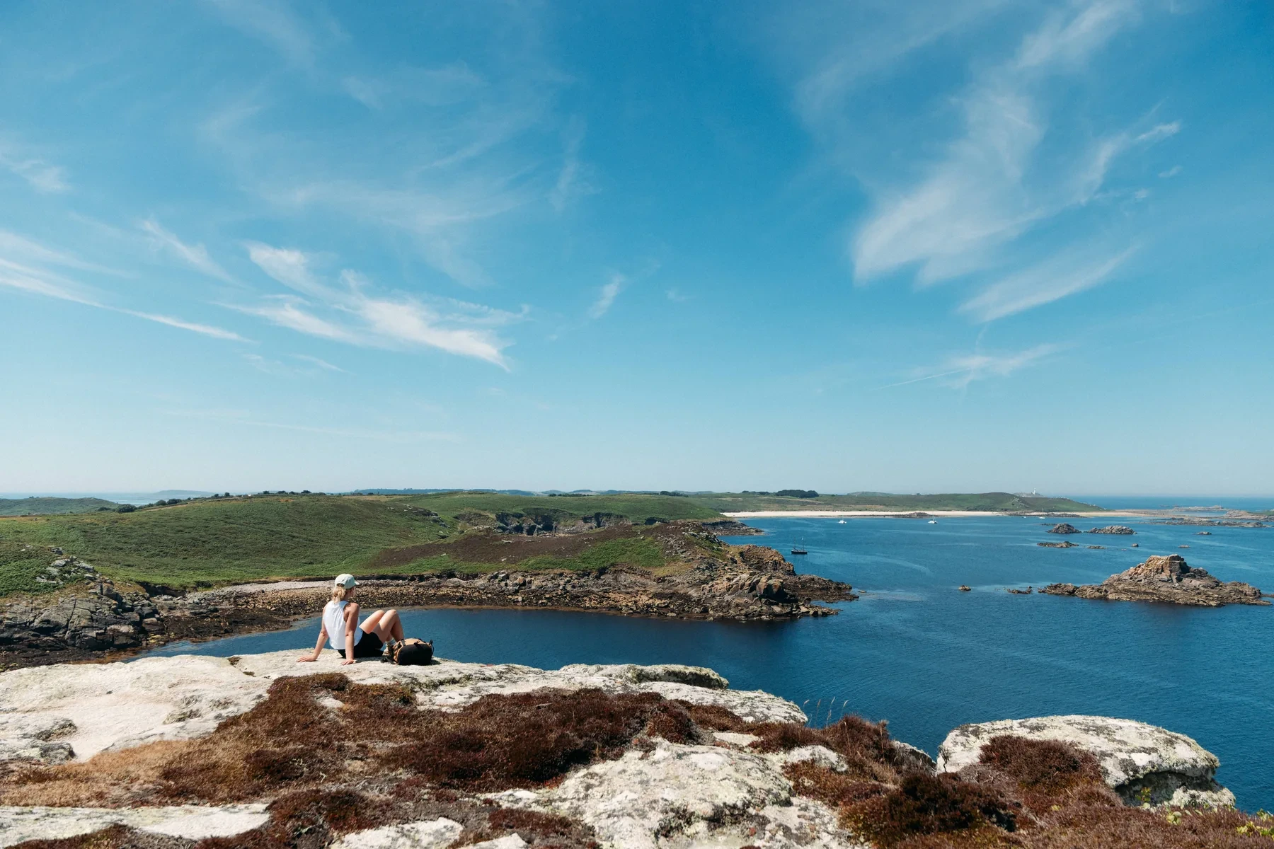 Lydia Cooke overlooking the coast of St Martin’s during an Isles of Scilly Travel destination shoot.