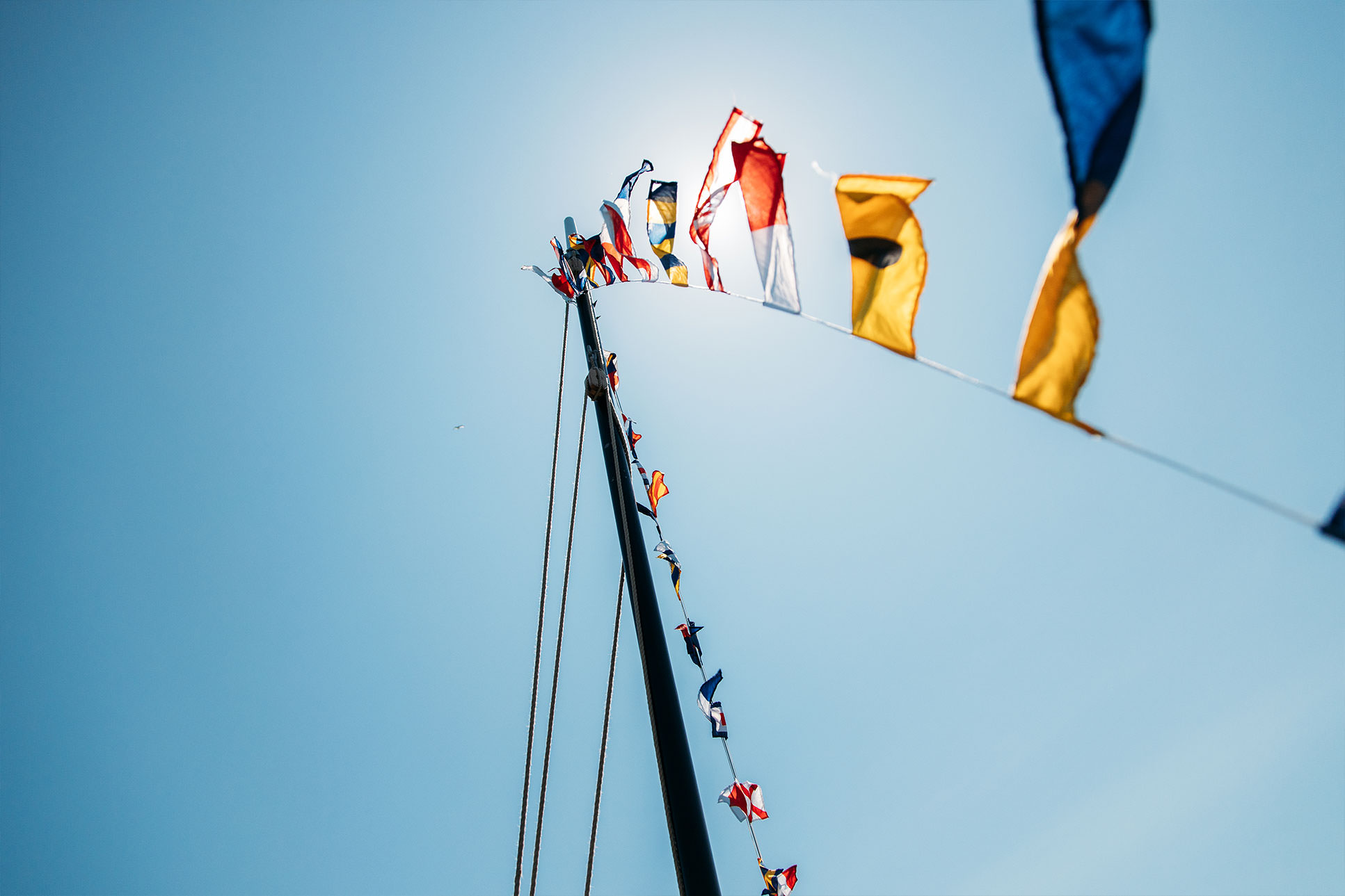 Maritime signal flags flying from Jonik's mast, photographed during filming of the Heritage Boat Tours, Falmouth Harbour.
